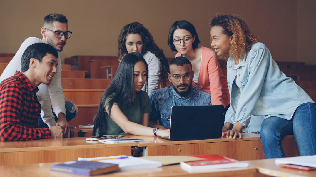 diverse students coding together
