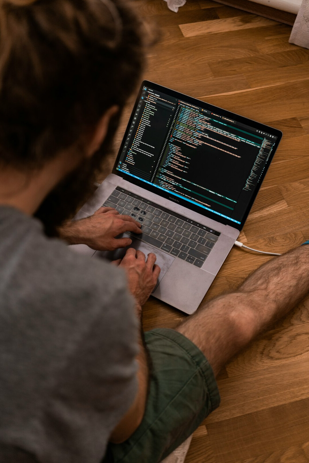 student typing code on laptop